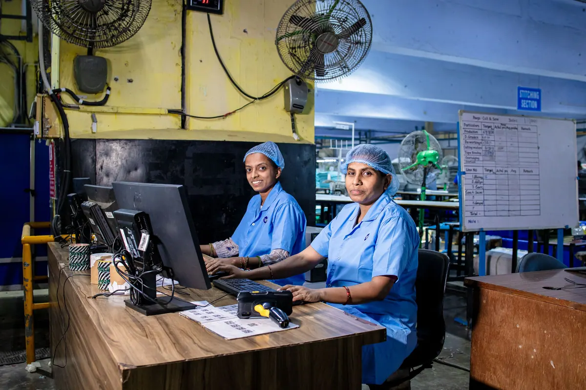 Two staff working at computers in a site office